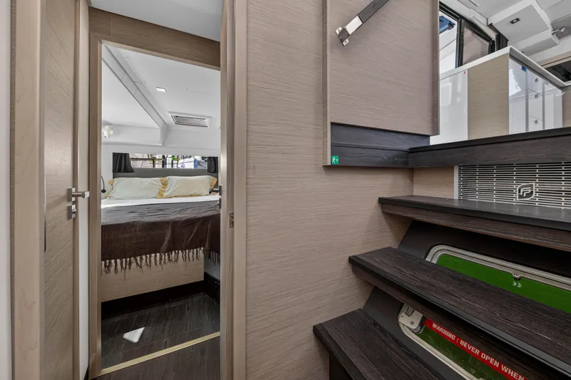 Slide: The Image of Interior of 2022 Fountaine Pajot Tanna 47 yacht, featuring a cozy bedroom and modern staircase. - 81
