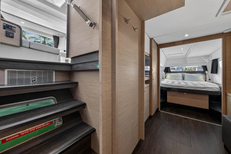 Slide: The Image of Interior of 2022 Fountaine Pajot Tanna 47 yacht, featuring modern bedroom and staircase. - 97