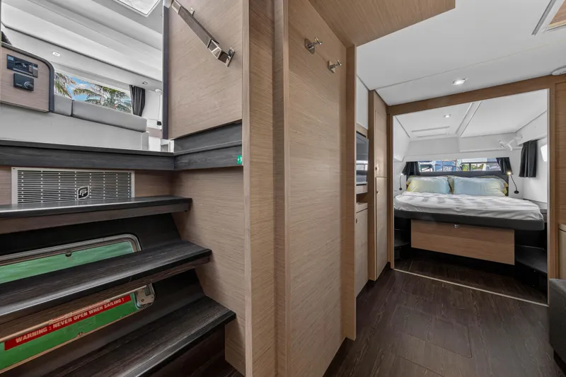 Slide: The Image of Interior of 2022 Fountaine Pajot Tanna 47 yacht, featuring modern bedroom and wooden finishes. - 98