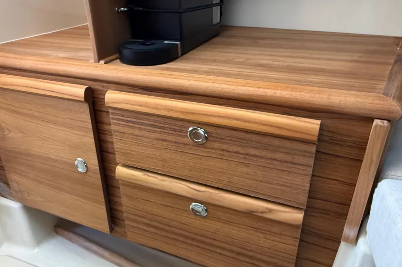 Slide: The Image of Wooden cabinetry inside 2026 Ranger Tugs R-27 boat, featuring sleek drawers and modern design. - 26