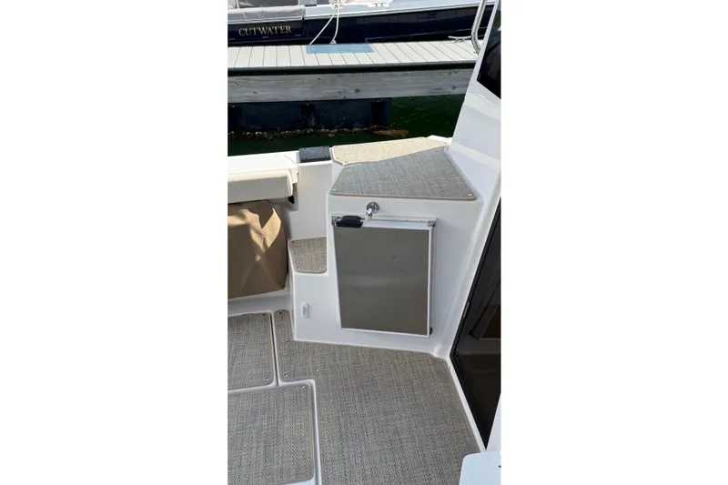 Slide: The Image of 2026 Ranger Tugs R-27 boat interior with carpeted flooring and storage compartment. - 3