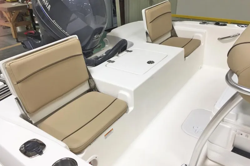 Slide: The Image of 2021 NauticStar 191 Hybrid boat dashboard with steering wheel and controls. - 12