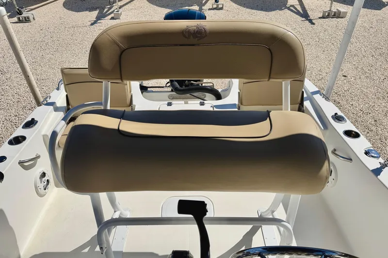 Slide: The Image of 2021 NauticStar 191 Hybrid boat interior with tan seating and steering console. - 17