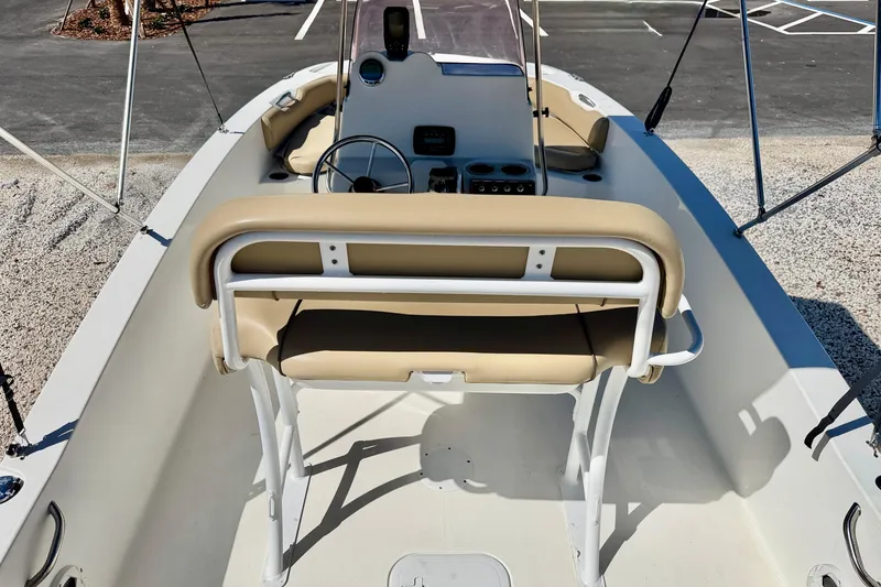 Slide: The Image of 2021 NauticStar 191 Hybrid boat interior with beige seating and steering console. - 18