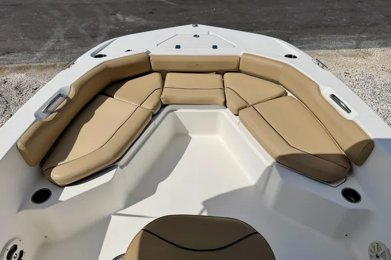 Slide: The Image of 2021 NauticStar 191 Hybrid boat with tan cushioned seating in bow area. - 19