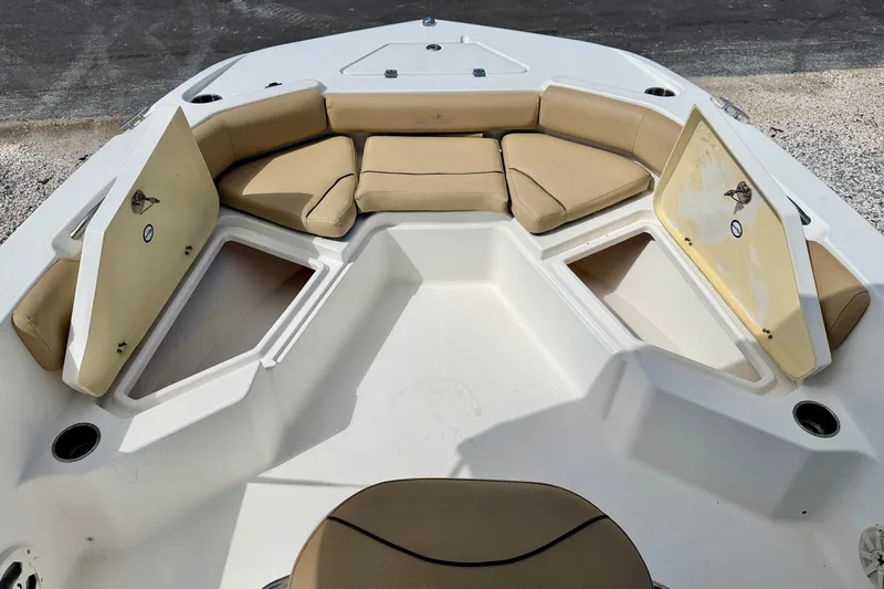 Slide: The Image of 2021 NauticStar 191 Hybrid boat interior with tan seating and storage compartments open. - 20