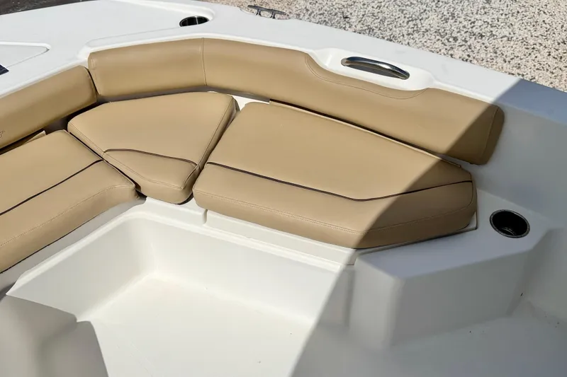 Slide: The Image of 2021 NauticStar 191 Hybrid boat with tan cushioned seating and white deck. - 21