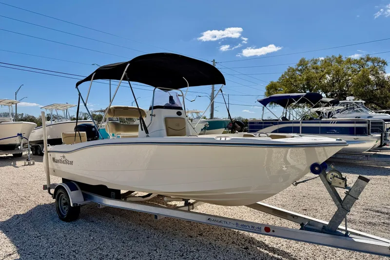 Slide: The Image of 2021 NauticStar 191 Hybrid boat on trailer, displayed outdoors under clear sky. - 3