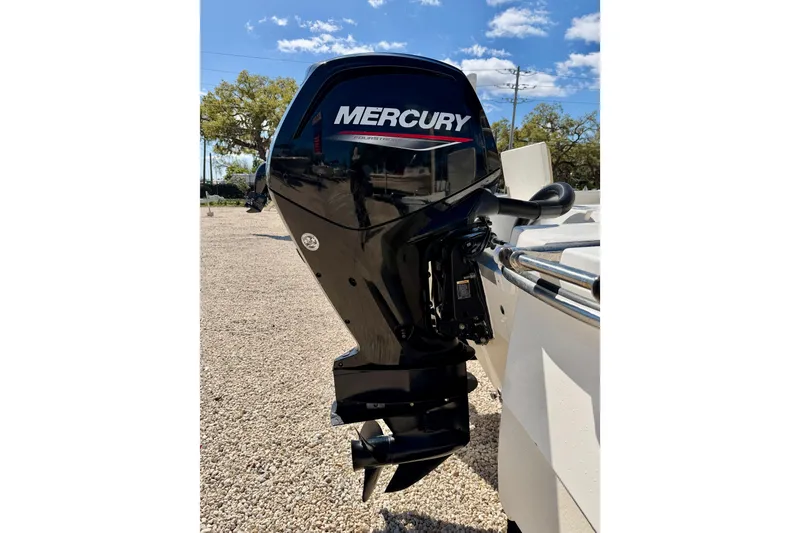 Slide: The Image of Mercury outboard motor on 2021 NauticStar 191 Hybrid boat, sunny day background. - 30