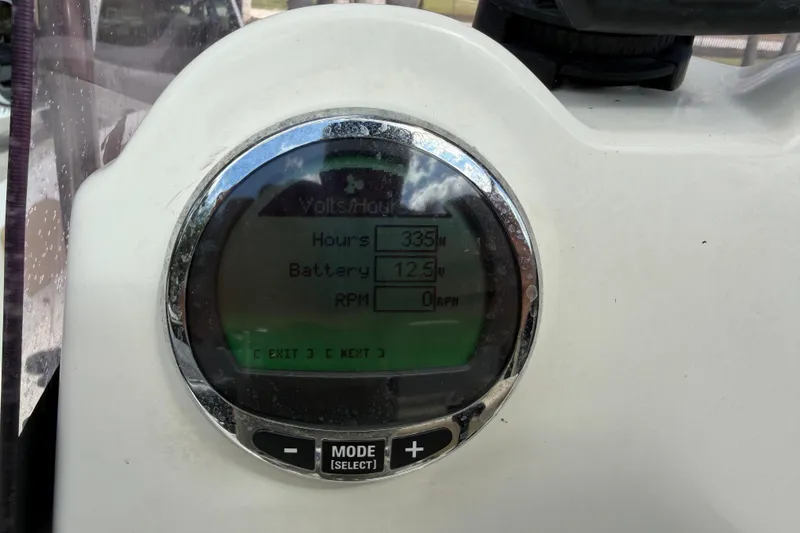 Slide: The Image of 2021 NauticStar 191 Hybrid boat with Mercury engine on trailer, parked outdoors. - 5