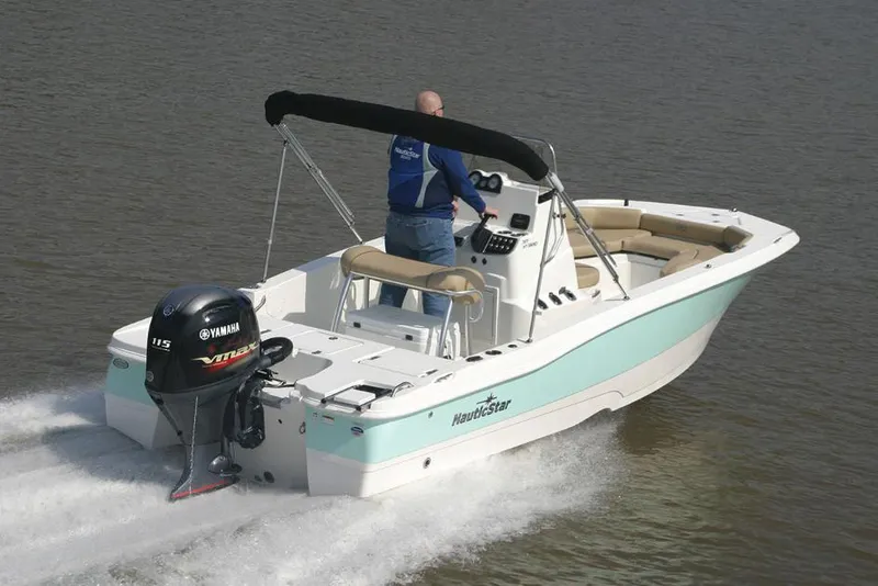 Slide: The Image of 2021 NauticStar 191 Hybrid boat with Mercury engine on trailer, parked outdoors. - 7