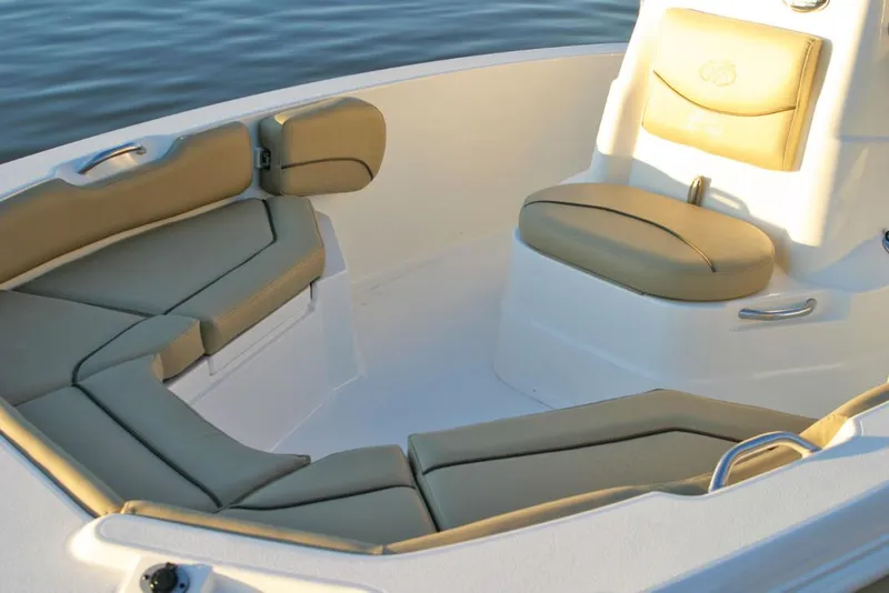 Slide: The Image of 2021 NauticStar 191 Hybrid boat interior with tan seating and white console. - 9
