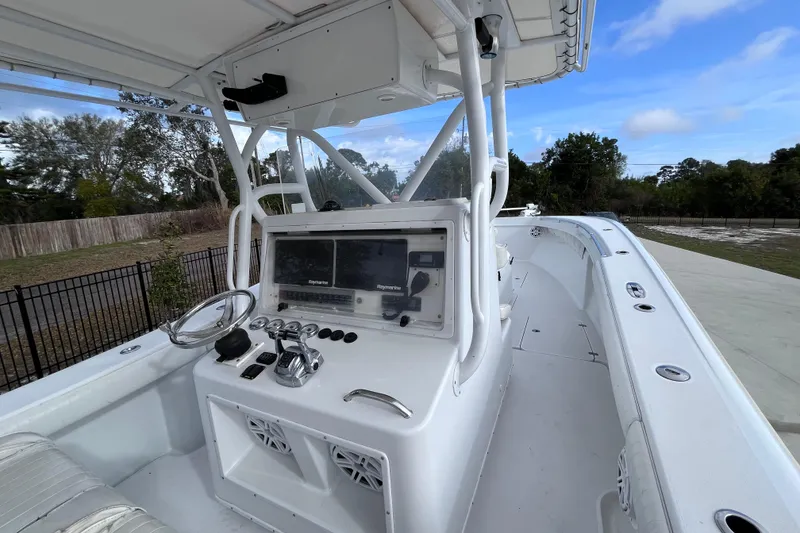 Slide: The Image of 2004 Yellowfin 36 Offshore boat cockpit with steering wheel and navigation system. - 13