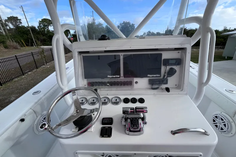 Slide: The Image of 2004 Yellowfin 36 Offshore boat dashboard with steering wheel and Raymarine electronics. - 14