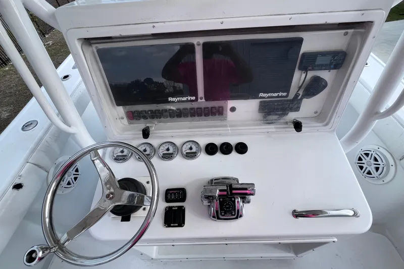 Slide: The Image of 2004 Yellowfin 36 Offshore boat dashboard with Raymarine electronics and steering wheel. - 15