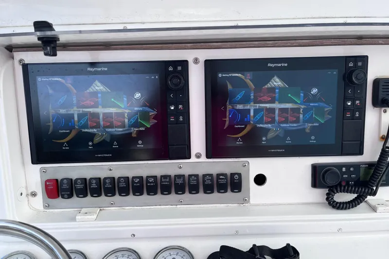 Slide: The Image of Control panel of a 2004 Yellowfin 36 Offshore boat with Raymarine displays. - 16