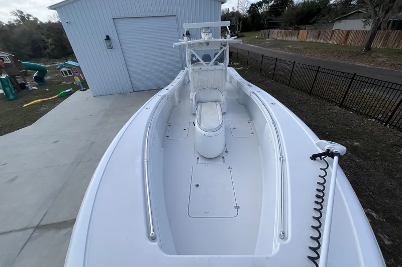 Slide: The Image of 2004 Yellowfin 36 Offshore boat parked beside a garage, showcasing spacious deck. - 20