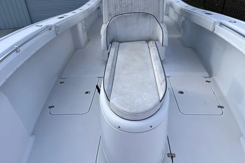 Slide: The Image of 2004 Yellowfin 36 Offshore boat interior with white seating and storage compartments. - 22