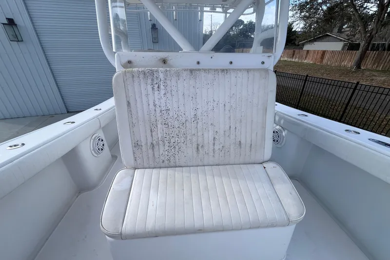 Slide: The Image of 2004 Yellowfin 36 Offshore boat seat with visible wear and dirt. - 23