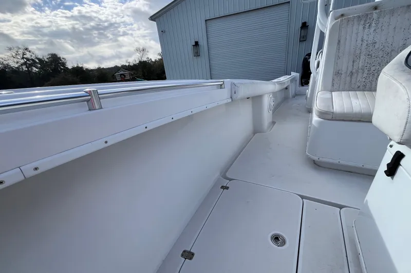 Slide: The Image of 2004 Yellowfin 36 Offshore boat interior with white seating and storage compartments. - 24