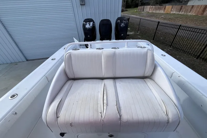 Slide: The Image of 2004 Yellowfin 36 Offshore boat with white seating and dual outboard motors. - 26