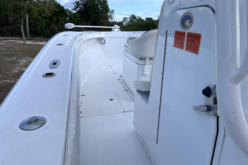 Slide: The Image of 2004 Yellowfin 36 Offshore boat deck, featuring white seating and storage compartments. - 28