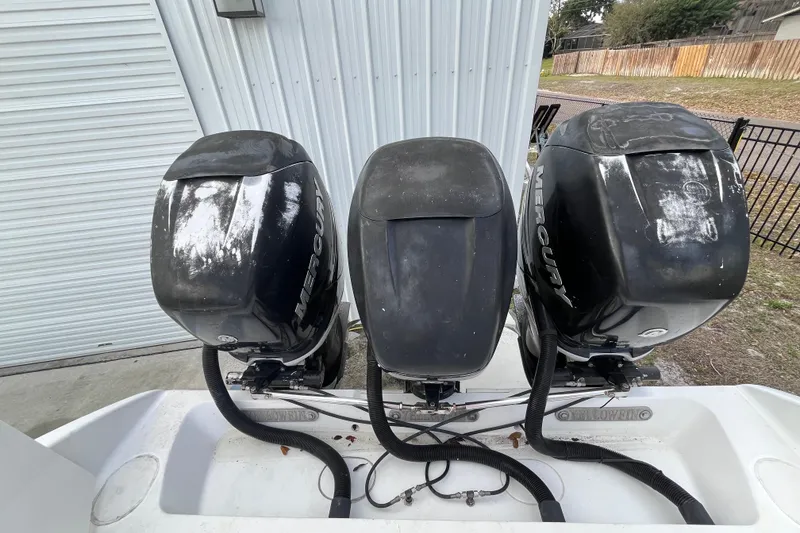 Slide: The Image of 2004 Yellowfin 36 Offshore boat with three Mercury outboard engines. - 30
