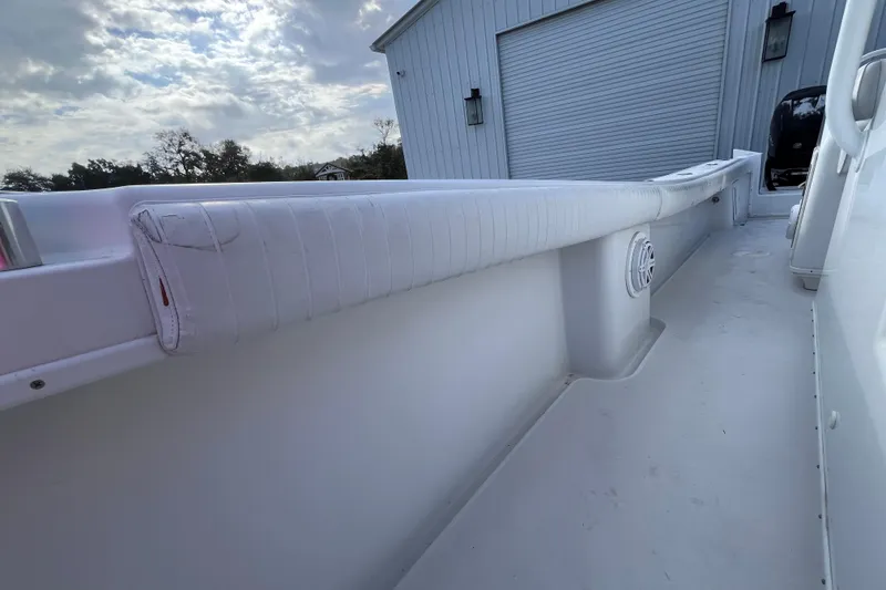 Slide: The Image of 2004 Yellowfin 36 Offshore boat interior with white cushioned seating and speaker. - 33