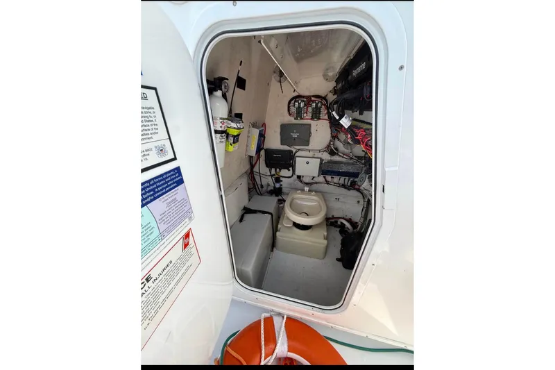 Slide: The Image of 2004 Yellowfin 36 Offshore boat interior with toilet and electrical equipment. - 4