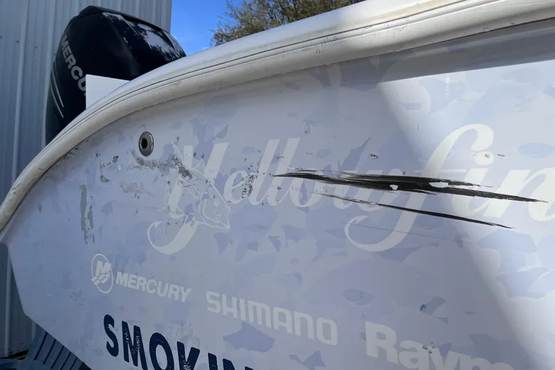 Slide: The Image of 2004 Yellowfin 36 Offshore boat with visible scratches and Mercury engine. - 45