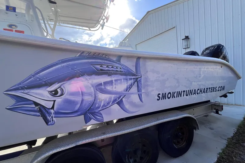 Slide: The Image of 2004 Yellowfin 36 Offshore boat with tuna graphic and "smokintunacharters.com" text. - 46