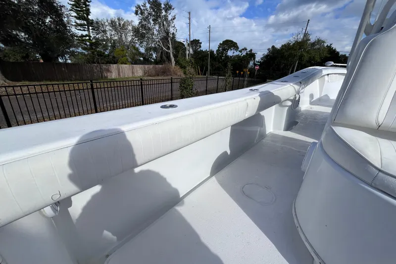 Slide: The Image of 2004 Yellowfin 36 Offshore boat deck with white seating and clear sky background. - 48