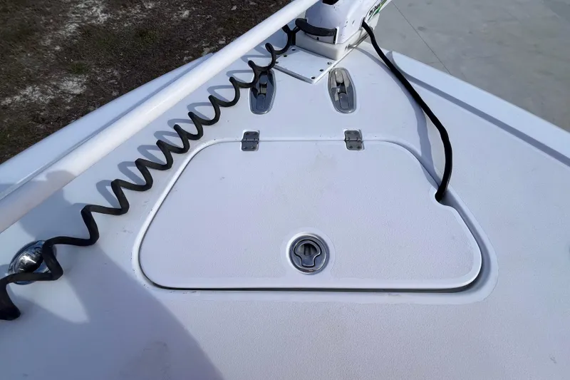 Slide: The Image of Bow deck of 2004 Yellowfin 36 Offshore boat with hatch and coiled cable. - 51