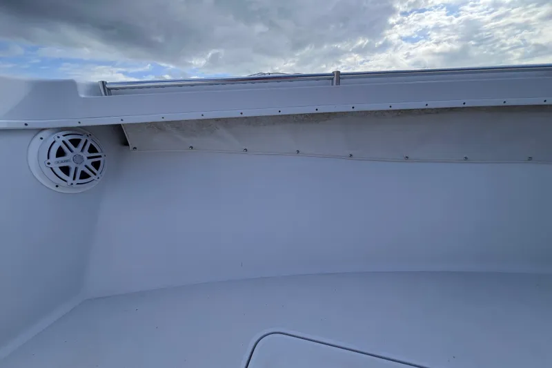 Slide: The Image of 2004 Yellowfin 36 Offshore boat interior with speaker, under cloudy sky. - 53