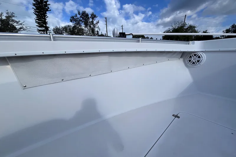 Slide: The Image of 2004 Yellowfin 36 Offshore boat interior with speaker and railing under blue sky. - 56