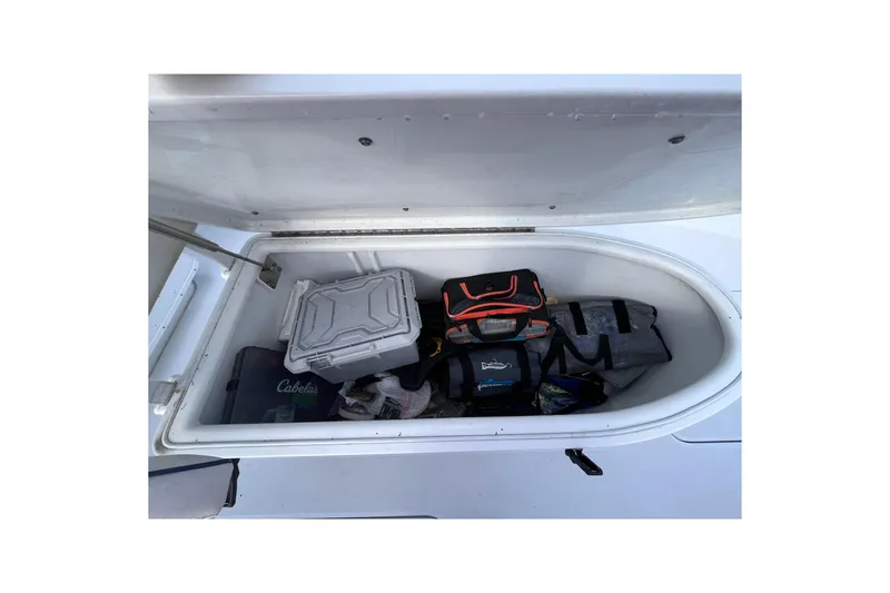 Slide: The Image of Storage compartment on 2004 Yellowfin 36 Offshore boat with various gear and bags. - 57