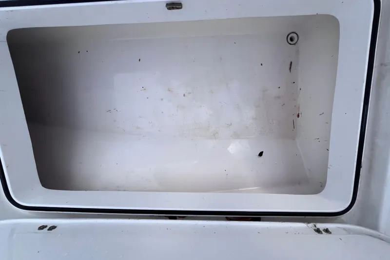 Slide: The Image of Open storage compartment on 2004 Yellowfin 36 Offshore boat, showing interior space. - 61