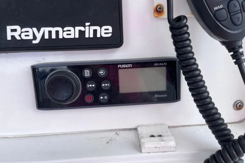 Slide: The Image of Control panel on 2004 Yellowfin 36 Offshore boat with Raymarine and Fusion MS-RA70 systems. - 64