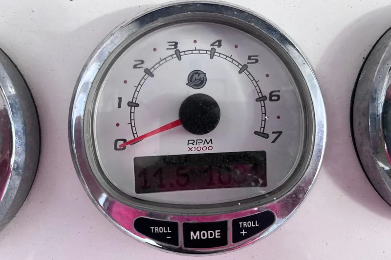 Slide: The Image of RPM gauge on 2004 Yellowfin 36 Offshore boat dashboard, displaying 115.7 hours. - 66