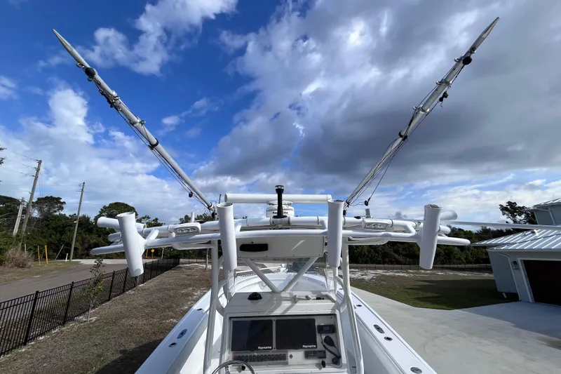 Slide: The Image of 2004 Yellowfin 36 Offshore boat with fishing outriggers under a partly cloudy sky. - 68