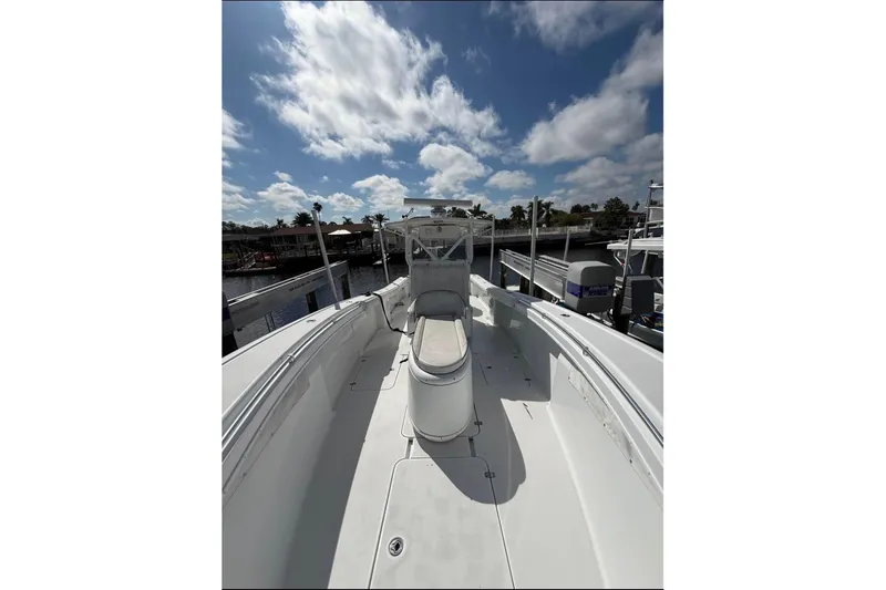 Slide: The Image of 2004 Yellowfin 36 Offshore boat docked under a partly cloudy sky. - 7