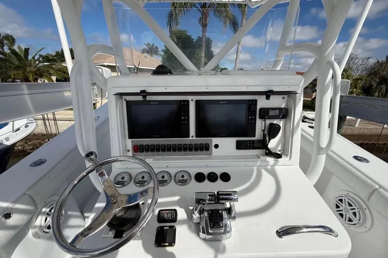 Slide: The Image of 2004 Yellowfin 36 Offshore boat dashboard with steering wheel and navigation equipment. - 9
