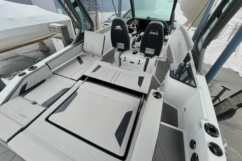 Slide: The Image of 2026 Monterey Elite 27 OB boat interior with modern seating and sleek design. - 13