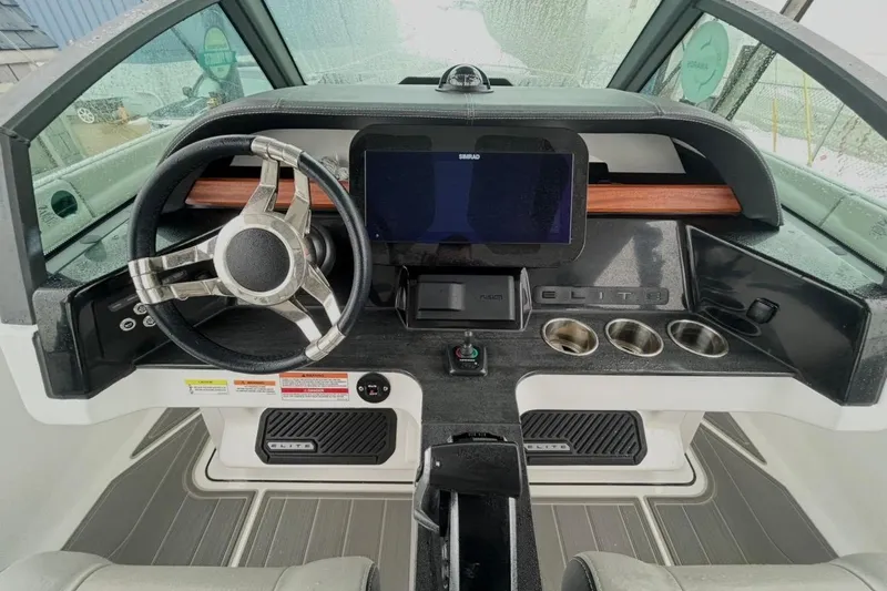 Slide: The Image of 2026 Monterey Elite 27 OB boat dashboard with steering wheel and digital display. - 8