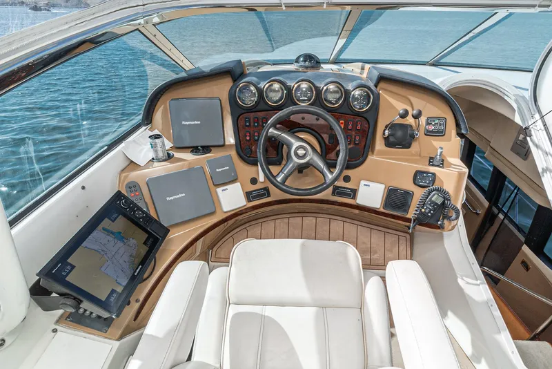 Slide: The Image of Pilothouse of 2003 Carver 570 Voyager, featuring navigation equipment and steering wheel. - 14