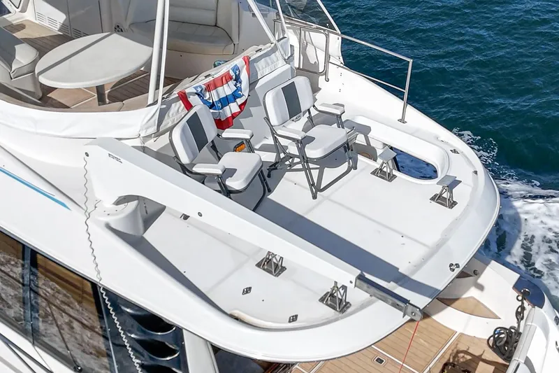 Slide: The Image of 2003 Carver 570 Voyager Pilothouse yacht deck with chairs and ocean view. - 20