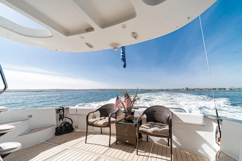 Slide: The Image of 2003 Carver 570 Voyager Pilothouse yacht deck with ocean view and seating area. - 27