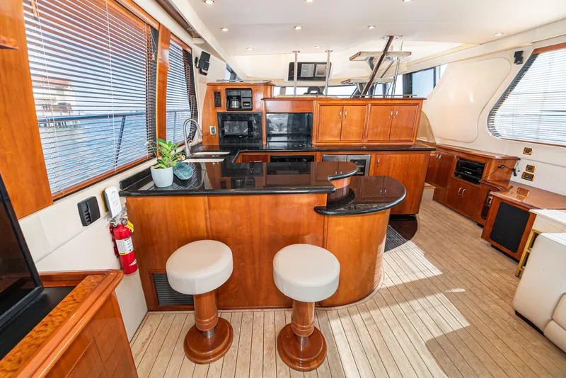 Slide: The Image of Luxurious interior of 2003 Carver 570 Voyager Pilothouse yacht with modern kitchen and seating. - 31