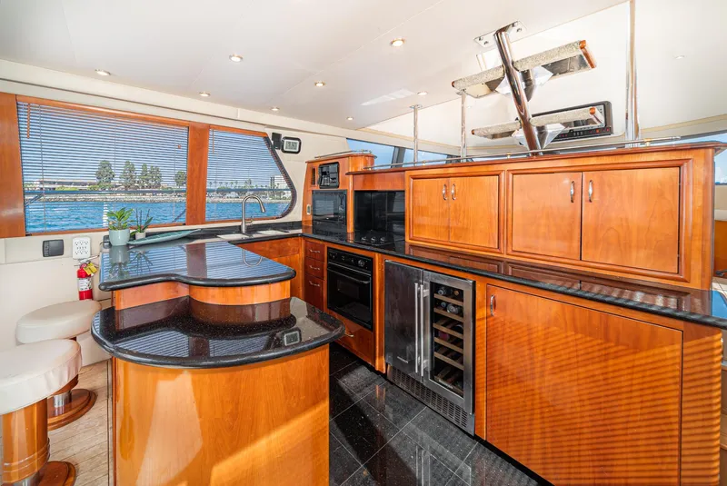 Slide: The Image of Luxurious kitchen interior of 2003 Carver 570 Voyager Pilothouse yacht with wood cabinetry. - 33
