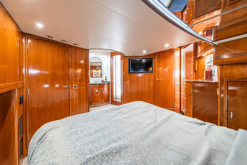 Slide: The Image of Luxurious 2003 Carver 570 Voyager Pilothouse bedroom with wood paneling and modern amenities. - 49